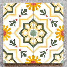 an artistic tile design with yellow and green flowers on it's sides, in the shape of a flower