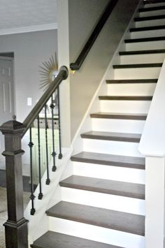 the stairs in this house are painted white and brown