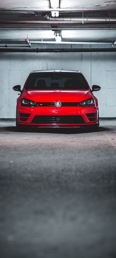 a red car parked in a parking garage