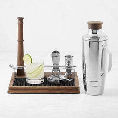 a pitcher, shaker and glasses on a tray