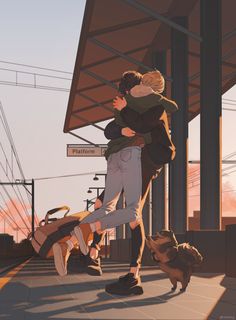 two people hugging each other in front of a train station with a dog running by