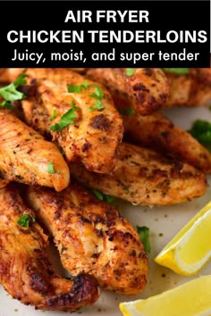 grilled chicken tenderions with lemon wedges and parsley garnish on a white plate