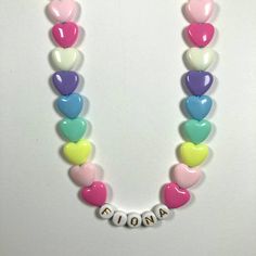 "You have just found the perfect gift for birthdays or Easter! This cute pastel, retro HEART necklace can come personalized or with hearts only. This 16\" stretchy necklace fits right over your head so it's easy to put on- no clasps needed. The matching bracelet is listed here: https://www.etsy.com/listing/909362079/kids-heart-bracelet-party-favor-girls?ref=shop_home_active_5&frs=1 Please check all selections and spelling prior to check out. Our custom jewelry is made to order so all sales a Customizable Pink Necklace For Birthday Gift, Cute White Heart Necklace For Valentine's Day, Personalized Playful White Necklace, Playful Personalized White Necklace, Cute Pink Heart Beads Necklace, Cute Personalized Heart Necklace For Mother's Day, White Heart Charm Necklace For Birthday, Fun Pink Necklace For Birthday, Cute Personalized Multicolor Necklaces