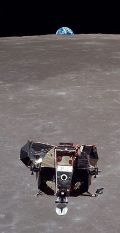 an astronaut's vehicle on the surface of the moon with earth in the background