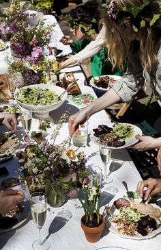 a group of people sitting around a table eating food