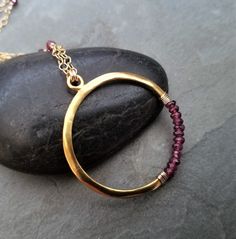 This item is made to order please allow 5 to 8 business days for your order to ship. This circle necklace was This necklace measures 16 inches in length and has a 2 inch extension chain for easy adjusting. The gold filled chain is intertwined with faceted rhodolite rondelle beads, the circle is completely handmade from 0.925 sterling silver followed by a heavy 14k gold plating and finished with genuine rhodolite rondelle beads. Burgundy Garnet Round Jewelry, Round Burgundy Garnet Jewelry, Burgundy Ruby Round Jewelry, Faceted Garnet Jewelry In Yellow Gold, Faceted Garnet Round Bead Jewelry, Ruby Jewelry With Faceted Round Beads, Round Faceted Ruby Beads Jewelry, Ruby Jewelry With Faceted Beads, Gold Garnet Jewelry With Gemstone Beads