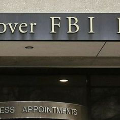 the front entrance to an office building with a sign above it that says, lower f b i