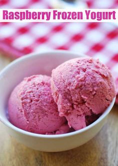 two scoops of pink ice cream in a white bowl