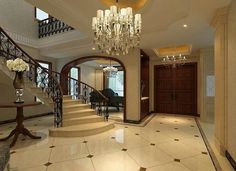 an elegant foyer with chandelier and marble floors