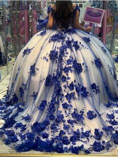 a woman in a blue and white ball gown