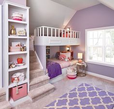 a bedroom with purple walls and white bunk beds, pink rugs on the floor