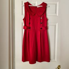 Super Cute Dress In A Beautiful Rich Red With A Very Vintage/Retro Style - New Without Tags. Peter Can Collar, Metal Button Details, Back Metal Zip Reposhing This Item I Purchased From @Puremuscle. **It's Marked A Large But Would Fit Best For A Medium I Think. Questions? Leave A Comment Below! Red A-line Dress With Button Closure, Red Party Dress With Button Closure, Red Sleeveless Dress With Buttons, Red Knee-length Dress With Buttons, Retro Party Dresses With Button Closure, Chic Red Dress With Button Closure, Red Sleeveless Mini Dress With Buttons, Red Vintage Knee-length Mini Dress, Chic Red Dress With Buttons