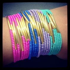 several different colored bracelets on someone's arm