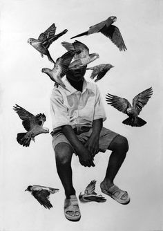 a black and white photo of a man sitting on top of birds in the air