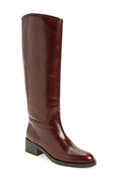 Every wardrobe craves this classic leather riding boot crafted with an asymmetric topline and framed with a rounded toe and chunky block heel. 1 3/4" heel; 1/2" platform 15 3/4" shaft; 15 1/2" calf circumference Pull-on style Leather upper/leather and textile lining/synthetic sole Imported Wool Sweater Dress, Brown Riding Boots, Riding Boot, Chunky Block Heels, Leather Riding Boots, Sell Out, Classic Leather, Sweater Sleeves, Jeffrey Campbell