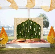 Embrace the traditional South Indian wedding aesthetic by incorporating lush banana leaves as the primary décor element for your Haldi ceremony. Complement the green foliage with garlands of tuberose and marigold flowers for a truly authentic and captivating ambiance. Nalugu Backdrop, Decoration Ideas For Haldi, Mehendi Stage, Leaf Decoration Ideas, Haldi Theme, Simple Crib, Haldi Celebration, Thread Ceremony