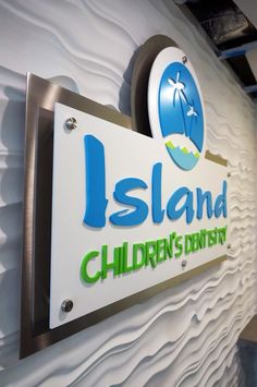 the sign for island children's dentist is displayed on the wall in front of it