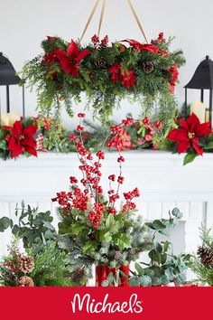 christmas wreaths hanging from the ceiling with candles and greenery in front of them