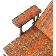 an orange and brown chair sitting on top of a wooden table