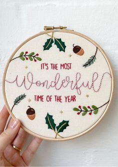 someone is holding up a embroidery hoop with the words it's the most wonderful time of the year