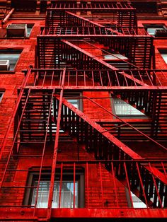 the red building has many windows and balconies