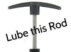 a black and silver pole with the words lube this rod above it