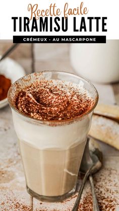 a close up of a drink in a glass with cinnamon sprinkles on top