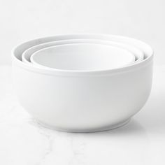 three white bowls stacked on top of each other