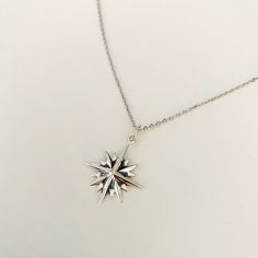 The North Star is what gives guidance and sense of familiarity for any globetrotter. 3 layers of stars on top of each other makes up a 16 point star. Let this celestial beauty adorn your neck. Match it with our silver moon and star ring. Made out of 925 sterling silver. Diameter : 25x 25 mm Comes gift wrappedMy jewellery is packaged in a sturdy gift box that protects it and makes it easily to store. Online store : www.raw-london.co.ukInstagram: @rawlondonjewelleryEmail me: sales@raw-london.co.uk Silver Star-shaped Celestial Charm Necklaces, Silver Star Charm Necklace In Celestial Style, Silver Star Charm Necklaces In Celestial Style, Dainty Silver Starburst Jewelry, Silver Celestial Charm Necklace With Star Charm, Silver Star-shaped Necklace With Compass Design, Sterling Silver Star-shaped Jewelry With Compass Design, Ohm Pendant, Opal Necklace Silver