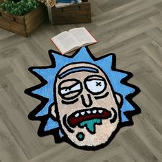 a rug with a cartoon character on it in the middle of a floor next to an open book