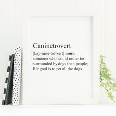 a white framed print with the definition of a dog