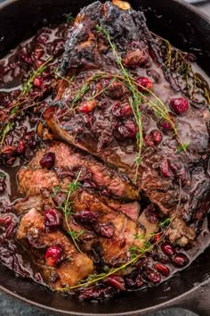 meat with cranberry sauce in a cast iron skillet