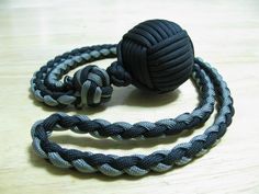 a ball of rope on top of a wooden table next to a black and white cord