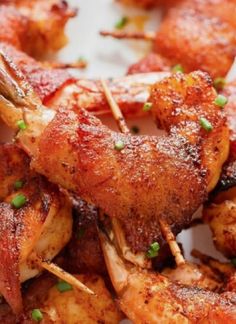 chicken skewers with green onions and parsley on the top are ready to be eaten