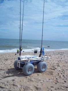 two fishing rods are attached to an atv on the beach