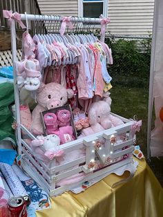 a baby's clothes rack with teddy bears and other items on display in front of a house