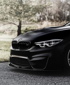 the front end of a black bmw car