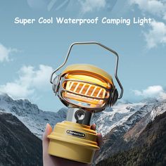 a hand holding a yellow lantern with mountains in the background and text super cool waterproof camping light