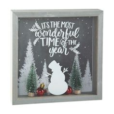 a shadow box with a snowman and christmas trees in the background that says, it's the most wonderful time of the year