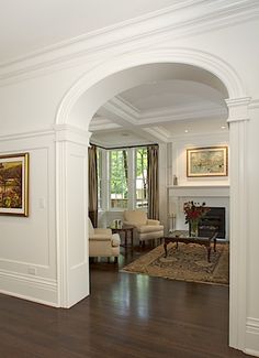 a living room filled with furniture and a fire place in the middle of a room