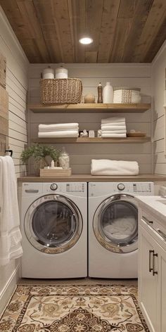 a washer and dryer in a small room with shelves above the washer