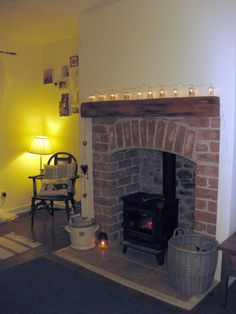 a living room with a fire place next to a chair