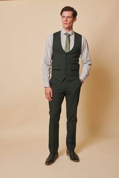 As worn by Leicester City midfielder Harry Winks! This stately three-piece suit for discerning gentlemen is a distinguished selection for formal occasions, like nuptials. Its timeless Prince of Wales check motif exudes elegance, while the elastane blend ensures ease of movement and comfort. The olive green hue accentuates any refined look. Model wears size 38R blazer, 38R waistcoat & 30R trousers. Features Slim fit Single-breasted waistcoat Prince of Wales check Notch lapel Single back vent Four Green Fitted Three-piece Suit For Groom, Fitted Green Three-piece Suit For Groom, Fitted Green Three-piece Suit For Grooms, Elegant Green Three-piece Groom's Suit, Elegant Green Three-piece Suit For Groom, Tailored Green Three-piece Suit For Groom, Fitted Green Tuxedo Three-piece Suit, Green Fitted Tuxedo Three-piece Suit, Fitted Double Breasted Suit For Wedding