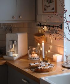 a kitchen counter topped with lots of food and candles