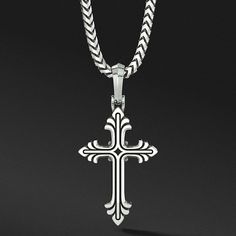 a sterling silver cross necklace hangs from a chain Classic Sterling Silver Engraved Cross Necklace, Classic Engraved Sterling Silver Cross Necklace, Classic Engraved Crucifix Cross Necklace, Silver Cross Necklace For Men, Classic Sterling Silver Cross Charm, Silver Polished Cross Pendant, Silver Cross Pendant For Men, Father's Day Silver Cross Pendant Necklace, Oxidized Cross Pendant Necklace