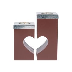 two brown boxes with white heart cut out of them, on top of each other