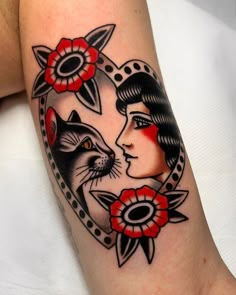 a woman with a cat and flower tattoo on her arm