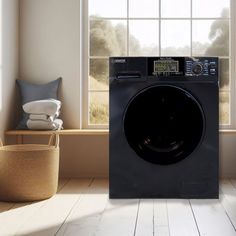 a washing machine sitting in front of a window