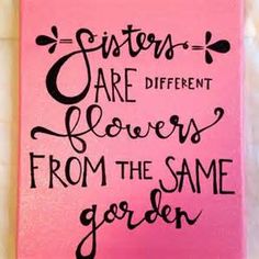 a pink canvas with black lettering that says sisters are different flowers from the same garden