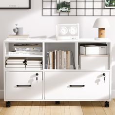 a white bookcase with two drawers and some books on the bottom shelf next to it